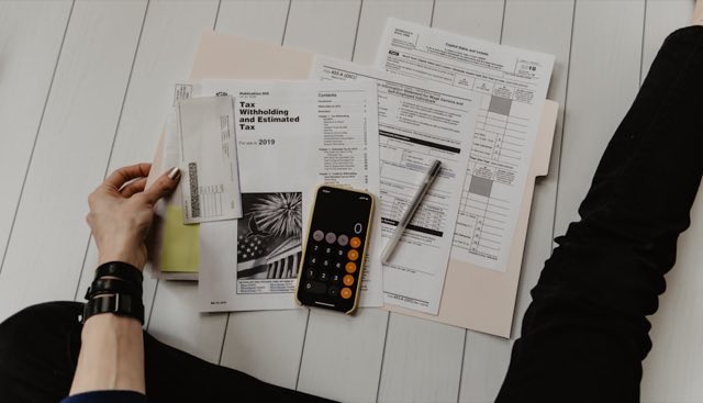 Tax paperwork and a calculator on a desk