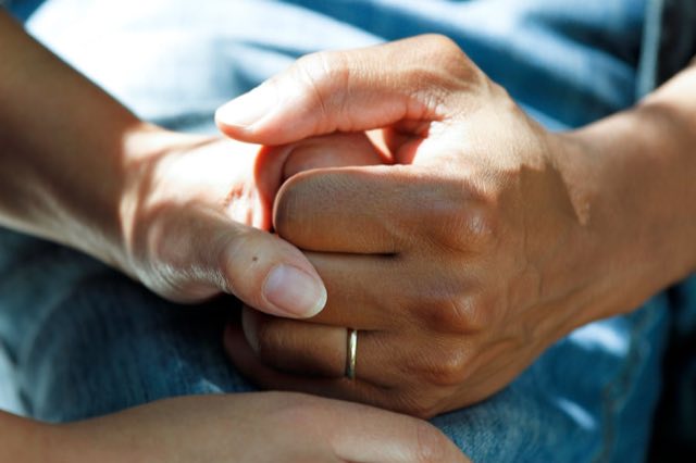 Two hands held in care
